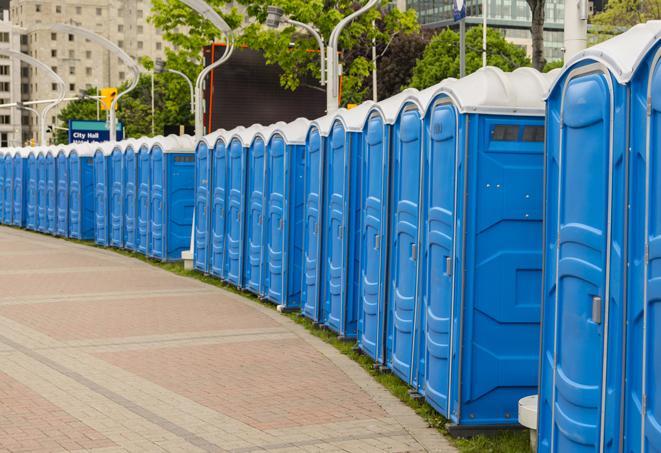 a row of sleek and modern portable restrooms at a special outdoor event in Hospers, IA